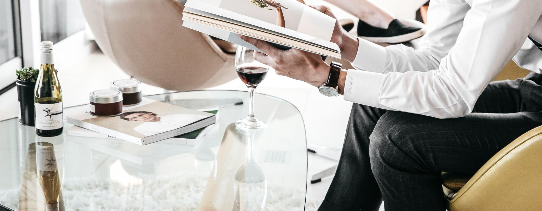 Lifestyle photo of a group of people sitting at a table with wine glasses and papers